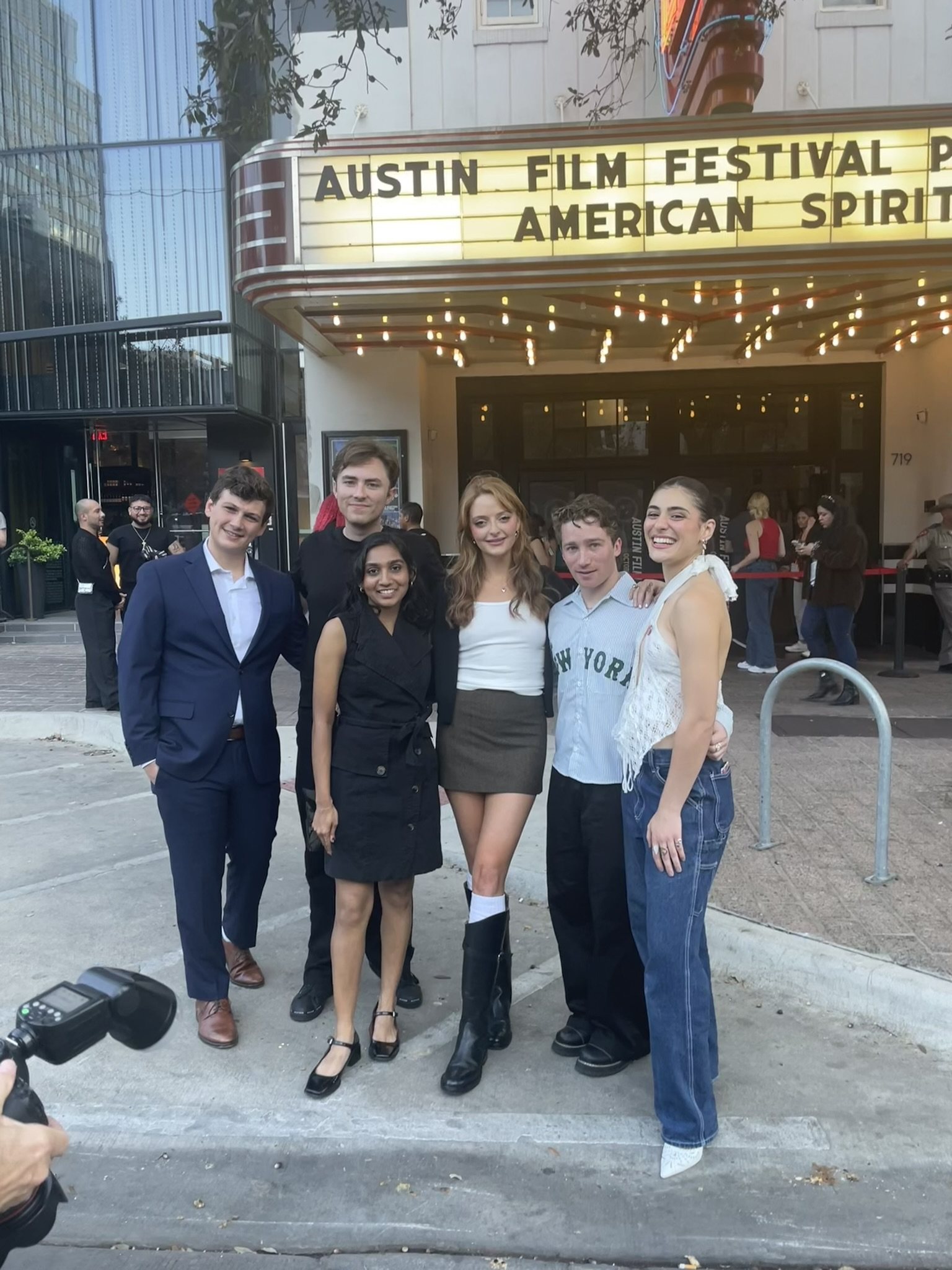 Eric stands with a group outside a film-festival venue.