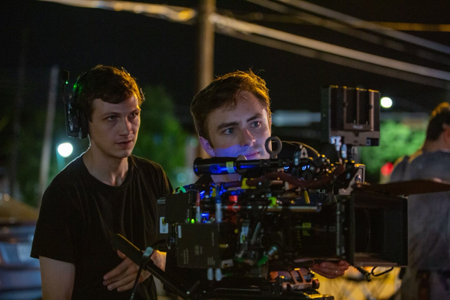 Eric works behind a cinema camera during a nighttime production.