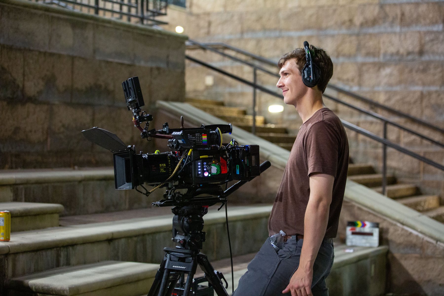 Eric working beside a cinema camera on an outdoor production set.