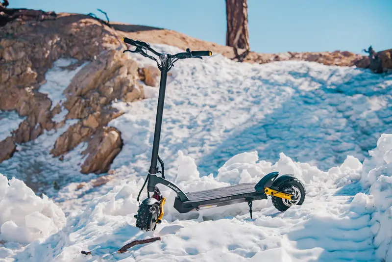 Electric scooter photographed against snow and blue ice.